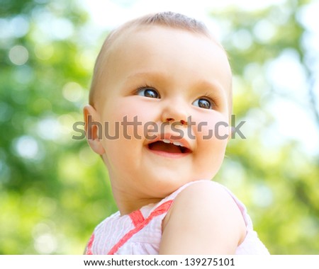 Little Baby Girl Portrait outdoor. Cute Child over nature background closeup