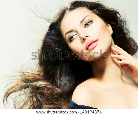 Beauty Girl portrait with long Hair. Beautiful Brunette Woman with Blowing Healthy Hair. Natural Beauty