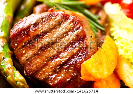 Grilled Beef Steak Meat with Fried Potato, Asparagus and Cherry Tomato. Steak Dinner. Food