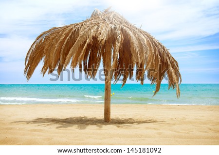 Vacation Concept. Palapa Sun Roof Beach Umbrella in Torremolinos, Spain. Costa del Sol