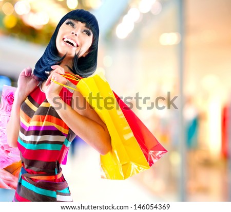 Fashion Shopping Girl Portrait. Beauty Woman with Shopping Bags in Shopping Mall. Shopper. Sales. Shopping Center