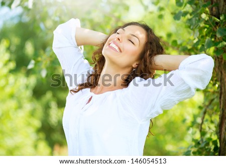 Beautiful Young Woman Outdoor. Enjoy Nature. Healthy Smiling Girl in the Park