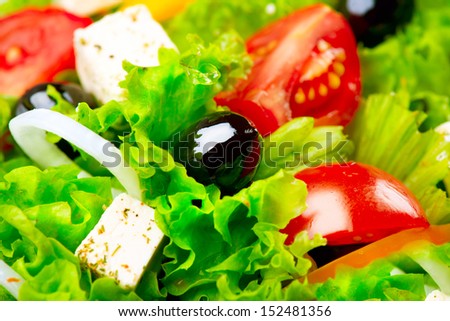 Salad. Greek Salad Background. Mediterranean Salad close up with Feta Cheese, Tomatoes and Olives