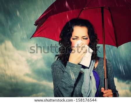 Sneezing Woman With Umbrella Over Autumn Rain Background. Sick Woman Outdoors. Flu. Girl Caught Cold. Sneezing Into Tissue. Headache. Virus. Bad Weather