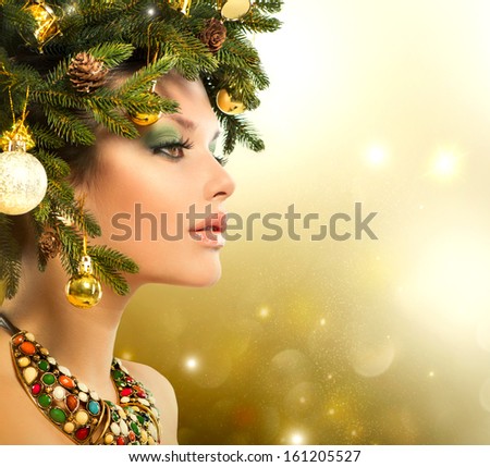 Christmas Winter Woman. Beautiful New Year And Christmas Tree Holiday Hairstyle And Make Up. Beauty Fashion Model Girl Over Holiday Blinking Background. Creative Hair Style Decorated With Baubles