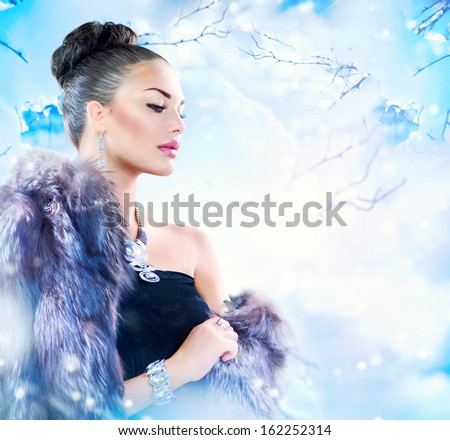 Winter Woman in Luxury Fur Coat. Beauty Fashion Model Girl in Blue Fox Fur Coat. Beautiful Luxury Winter Lady