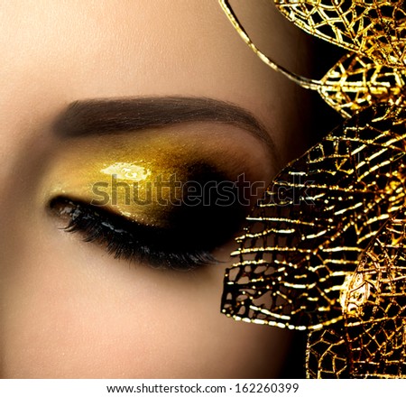 Fashion Glamour Eyes Makeup. Glamor Golden Make-up. Holiday Glittering Gold Makeup