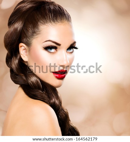 Hair Braid. Beautiful Woman With Healthy Long Brown Hair. Hairdressing. Hairstyle. Beauty Glamour Fashion Model Girl Portrait. Perfect Skin And Makeup Holiday Make Up. Blue Eyes And Red Lipstick