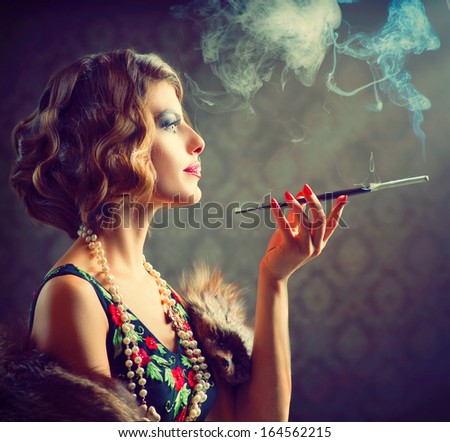 Retro Woman Portrait. Beautiful Woman With Mouthpiece. Cigarette. Smoking Lady. Vintage Styled Black And White Photo. Old Fashioned Makeup And Finger Wave Hairstyle. 20\'S Or 30\'S Style.
