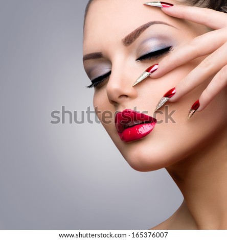 Fashion Beauty Model Girl. Manicure And Make-Up. Sexy Red Lips And Nail Art. Beautiful Woman With Long Nails And Luxury Makeup. Beautiful Girl Face And Hand