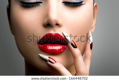 Fashion Beauty Model Girl. Manicure And Make-Up. Nail Art. Beautiful Woman With Red Nails And Lips. Luxury Makeup. Beautiful Girl Face And Hand Close-Up. Perfect Skin