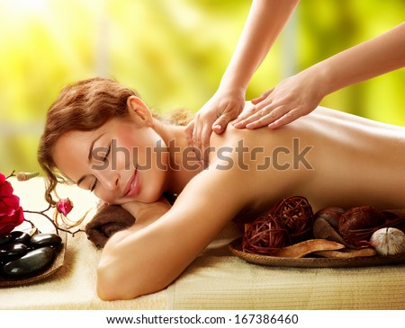 Spa. Beautiful Woman in Spa Salon getting Massage. Healthy massage of body in spa salon. Beauty treatment concept. Masseur doing massage. Relaxing