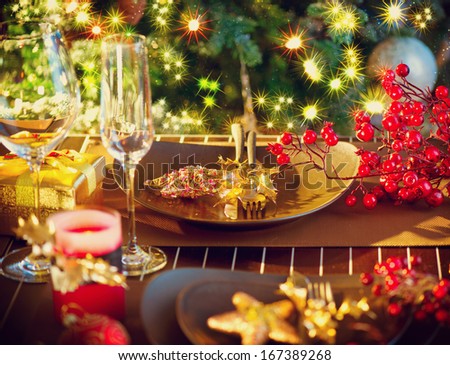 Christmas And New Year Holiday Table Setting with Champagne. Celebration. Place setting for Christmas Dinner. Holiday Decorations. Decor. Served Table