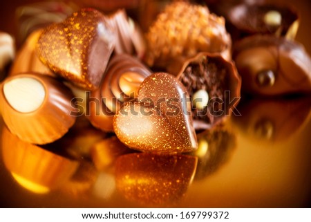 Valentine Chocolates. Assorted Chocolate Candies. Chocolate Sweets. Candy Border Design Over Golden Background. Heart Shaped Chocolate