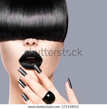 High Fashion Model Girl Portrait with Trendy Hair style, Black Make up and Manicure. Long Black Glossy Fringe Hairstyle, Black Matte Nail Polish and Lipstick. Woman Makeup. Haircut
