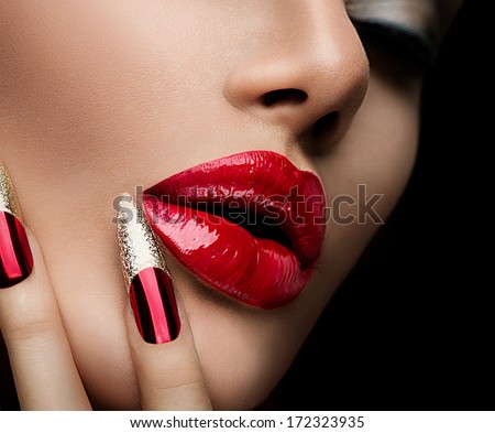 Beauty Concept. Fashion Model Girl Face Isolated On Black Background. Makeup And Manicure. Red Long Nails And Red Glossy Lips. Sensual Mouth. Beautiful Sexy Lips. Fashion. Make-Up. Perfect Skin