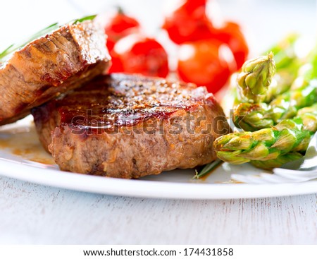 Steak. Grilled Beef Steak Meat with Vegetables - Asparagus and Cherry Tomato. Steak Dinner. Food. BBQ Grill. Berbeque