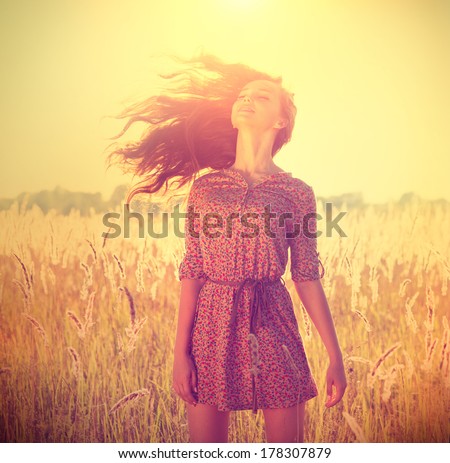 Beauty Romantic Girl Outdoors. Beautiful Teenage Model Girl In Casual Short Dress On The Field In Sun Light. Blowing Long Hair. Autumn. Glow Sun, Sunshine. Backlit. Toned In Warm Colors