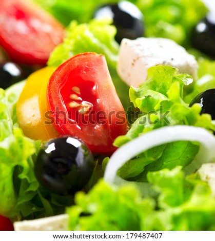 Salad. Greek Salad Background. Mediterranean Salad close up with Feta Cheese, Tomatoes and Olives. Food background