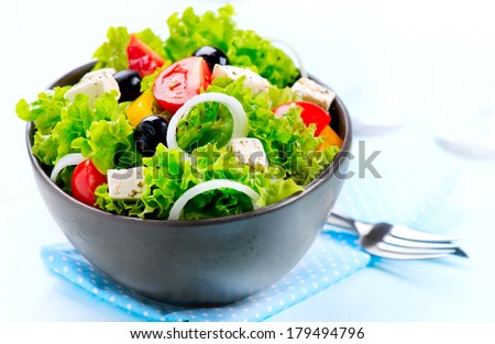 Salad. Greek Salad isolated on a White Background. Mediterranean Salad with Feta Cheese, Tomatoes and Olives. Healthy fresh vegetarian food