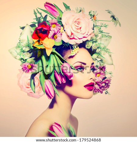 Spring Woman. Beauty Girl with Flowers Hair Style. Beautiful Model woman with Blooming flowers on her head. Nature Hairstyle. Summer. Holiday Creative Makeover. Fashion Makeup. Make up. Vogue Style
