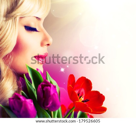 Beauty Woman with Spring Flower bouquet. Cheerful girl with a Bouquet of Tulip flowers. Isolated on a white background. Happy surprised model woman smelling flowers. Mothers Day