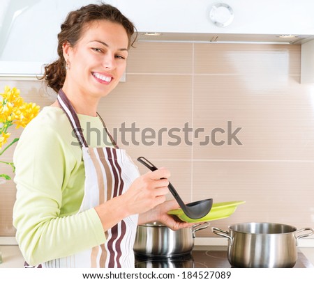 Young woman cooking healthy food at home in the kitchen. Diet. Dieting concept