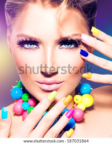 Fashion Beauty model girl with colorful Nails. Vivid rainbow manicure and accessories. Beautiful woman portrait with perfect makeup
