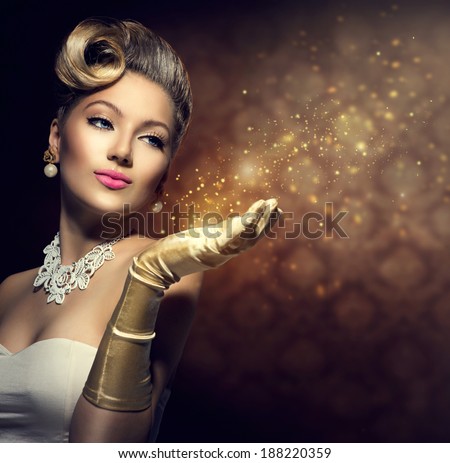 Retro Woman with magic in her hand. Beauty Fashion Vintage Style Lady with Beautiful Luxury Hairstyle, makeup, accessories. Golden Silk Gloves and dress