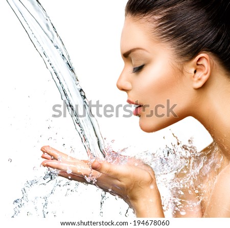 Beautiful Woman with splashes of water in her hands Beautiful Smiling model girl under splash of water with fresh skin over blue background Skin care Cleansing and moisturizing concept Beauty face Beautiful Woman with splashes of water in her hands Beautiful Smiling model girl under splash of water with fresh skin over blue background Skin care Cleansing and moisturizing concept Beauty face