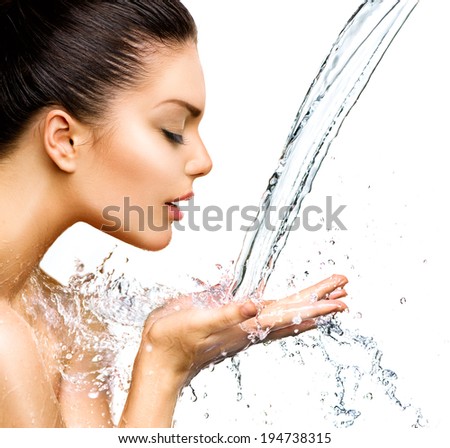 Beautiful Woman with splashes of water in her hands Beautiful Smiling model girl under splash of water with fresh skin over blue background Skin care Cleansing and moisturizing concept Beauty face Beautiful Woman with splashes of water in her hands Beautiful Smiling model girl under splash of water with fresh skin over blue background Skin care Cleansing and moisturizing concept Beauty face