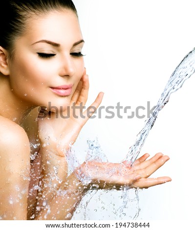 Beautiful Model Woman with splashes of water in her hands Beautiful Smiling girl under splash of water with fresh skin over blue background Skin care Cleansing and moisturizing concept Beauty face Beautiful Model Woman with splashes of water in her hands Beautiful Smiling girl under splash of water with fresh skin over blue background Skin care Cleansing and moisturizing concept Beauty face