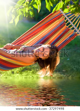 Happy Young Woman relaxing in hammock