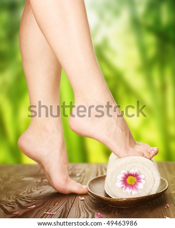 Spa.Beautiful Woman Legs over nature background