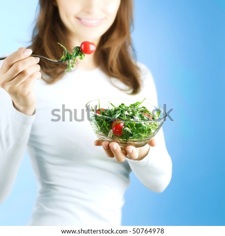Dieting Concept.Happy Young Woman eating vegetable salad