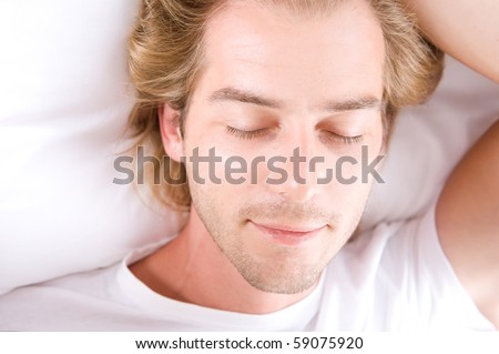 Handsome Man Sleeping in his Bed
