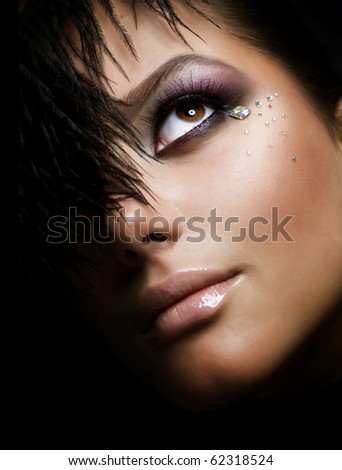 Fashion Girl's Face.Perfect makeup.Isolated on Black