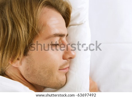 Young Man Sleeping in his Bed
