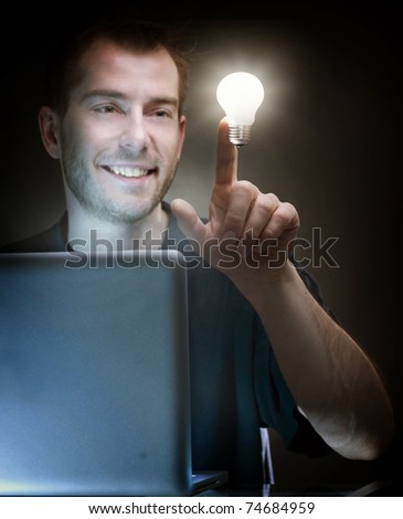 Young Man With Laptop and Idea light Bulb