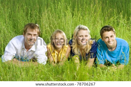 Happy Friends outdoor lying on a green grass