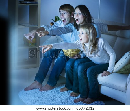stock photo : Family watching TV .True Emotions