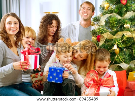 Happy Big family holding Christmas presents at home.Christmas tree