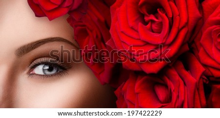 Beauty eyes makeup. Close-up of beautiful woman blue eye with red roses and stylish make up