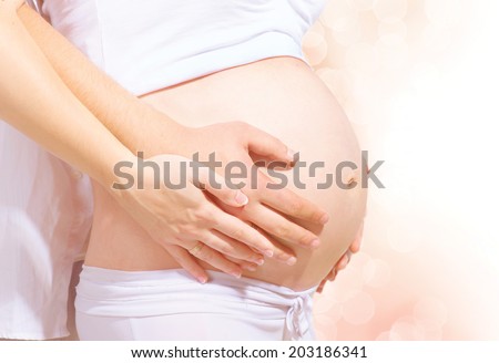 Pregnant Belly with Hands of mother and father. Baby Tummy with Hands of parents mom and dad. Baby Expecting. Pregnant Woman. Pregnancy concept