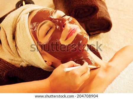 Chocolate Luxury Spa. Facial Mask. Spa therapy for young woman with cosmetic mask at beauty salon. Wellness. Chocolate Mask Facial Spa. Chocolate Treatments. Beauty Spa Salon