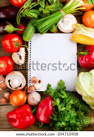 Fresh Organic Vegetables and Spices on a Wooden Background and Paper for Notes.Open Notebook and Fresh Vegetables Background. Diet. Dieting concept