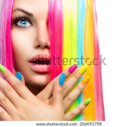 Beauty Girl Portrait with Colorful Makeup, Hair and Nail polish. Colourful Studio Shot of Surprised Woman face closeup. Vivid Colors. Manicure and Hairstyle. Rainbow Colors manicure