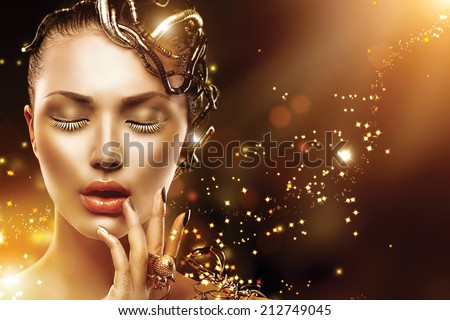 Model Girl face with gold skin, nails, make-up and accessories. Fashion Magic Woman with holiday golden makeup