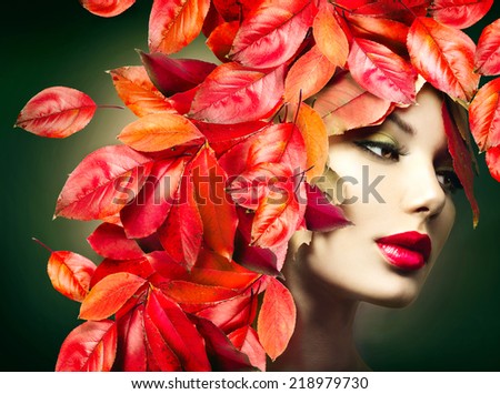 Autumn Girl Fashion Portrait. Fall. Beautiful Model woman with colourful autumn leaves hairstyle. Red Autumn leaves Hair. Fashion Art design