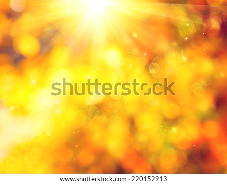 Autumn. Blurred Fall Abstract autumnal background with colorful leaves and sun